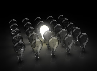 gropu of light bulbs with one shining