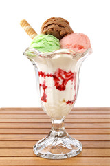 Multi flavor ice cream glass on wooden background. Shallow DOF
