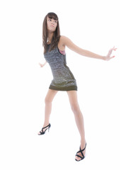 Beautiful woman in short dress poses over white