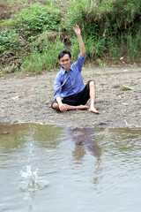 business man relaxing near by river
