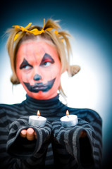 Halloween girl with candles, soft focus