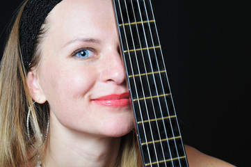 portrait of the nice woman behind fretboard