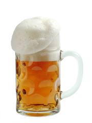 Mug of beer with overflowing foam head