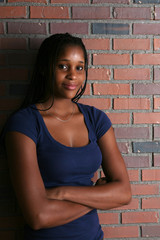 Fototapeta na wymiar natural light portriat of black teenage girl with arms crossed