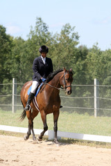 black teenage girl riding a horse with dust from the ground