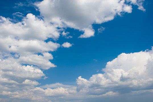 white clouds over deep blue sky background