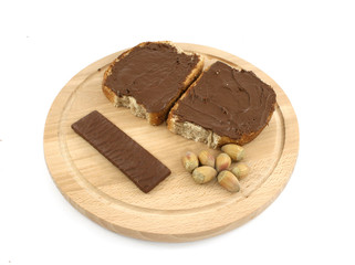 chocolate cream with bread on wooden plate