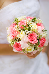 Wedding bouquet with white and pink roses in bride hand