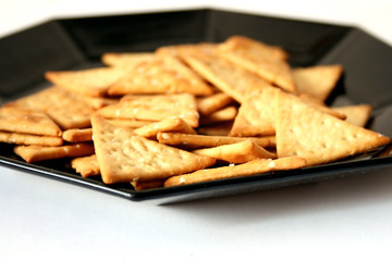 Gold triangle crackers on decorate plate.