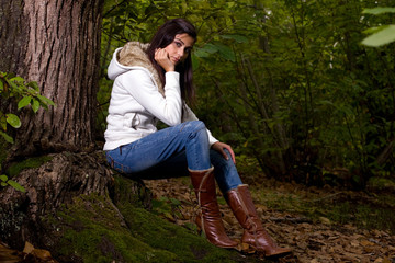 young woman on autumn forest under chestnut tree