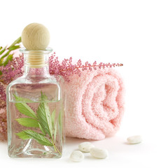 Jar with fresh leaves and towel (SPA concept)