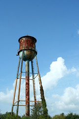 A Old rusty watertower against blue sky