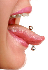 Obraz premium woman sticking out her tongue to show piercing