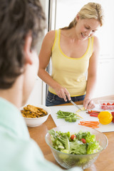 Obraz na płótnie Canvas Woman Talking To Husband While Preparing meal,mealtime