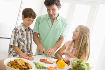 Obraz na płótnie Canvas Father And Children Prepare A meal,mealtime Together