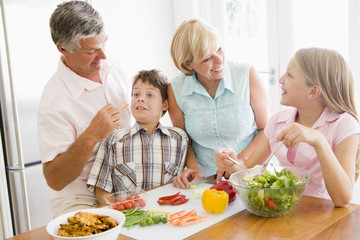 Grandparents And Grandchildren Prepare A meal,mealtime Together