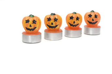 four halloween candles isolated on white