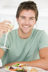 Young Man Enjoying meal,mealtime With A Glass Of Wine