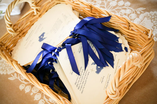 wedding programs in basket in blue and white