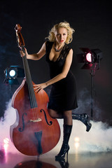 Young woman in studio with contrabass