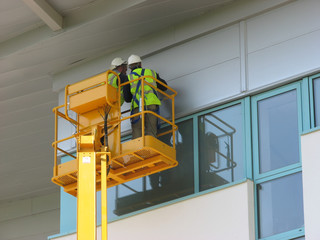 Two contruction workers working on new building