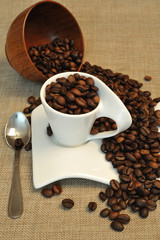 Close up of coffee beans and a white cup