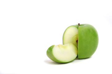 Close up of a green sliced apple on white background