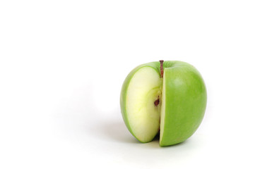 Close up of a green sliced apple on white background