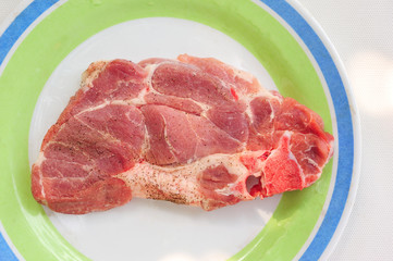 Raw of sruff meat on a plate, top view close up