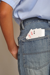 Close up of four aces in back pochet jeans