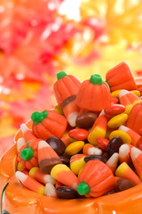 Orange pumpkin filled with delicious Halloween candies.