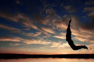 silhouette of happy man jumping