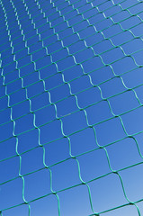 Nylon net pattern detail against a clear blue sky.