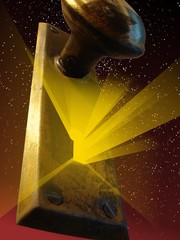 Light getting out of a keyhole under an handle floating in space