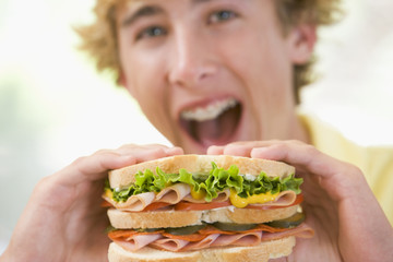 Teenage Boy Eating Sandwich