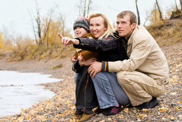happy family having fun by the lake