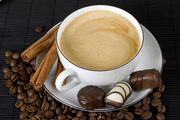 Cup of espresso coffee and chocolate candies