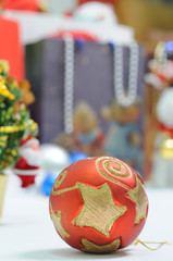 christmas bauble with present as blur background