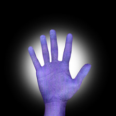 circuitboard hand over black background with light