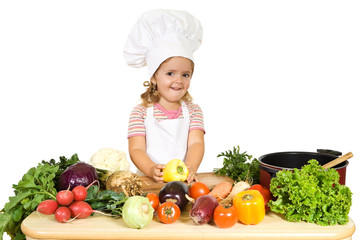 Happy little girl as a chef preparing vegetables for cooking © Ilike