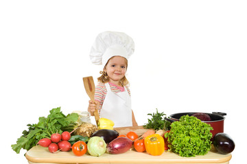 Happy little girl chef with lots of vegetables