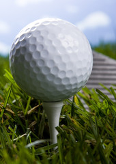 Golf ball on grass with driver