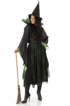 nice woman in green and black witch dress with broom and hat