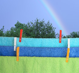 Towels hanging on background with rainbow
