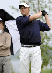 a golfer holding his finish after tee shot