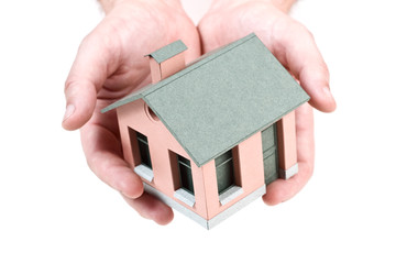 Model of the small house in human hands.