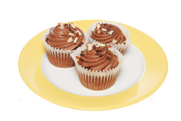 Chocolate cup cakes on a plate isolated on white