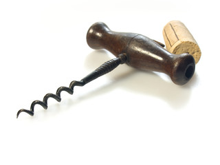Corkscrew with cork on white