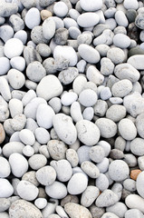 A close-up shot of smooth rocks on a beach in the Azores