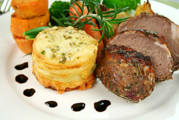 Baked lamb and potato stack with onions, beans and broccoli